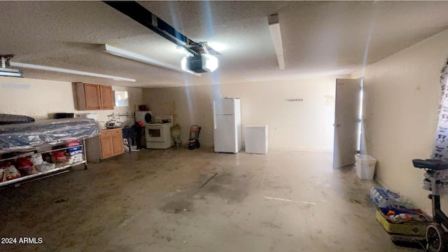 garage with washer / clothes dryer, a garage door opener, and white refrigerator