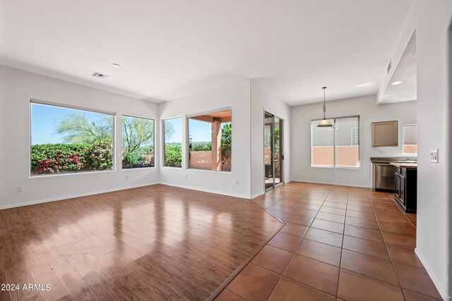 16914 E Britt Ct, Fountain Hills, AZ 85268 - unfurnished living room with baseboards, visible vents, tile patterned floors, and plenty of natural light