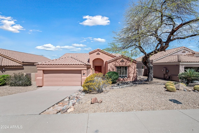 16914 E Britt Ct, Fountain Hills, AZ 85268 - mediterranean / spanish home with a garage, stucco siding, a tile roof, and concrete driveway