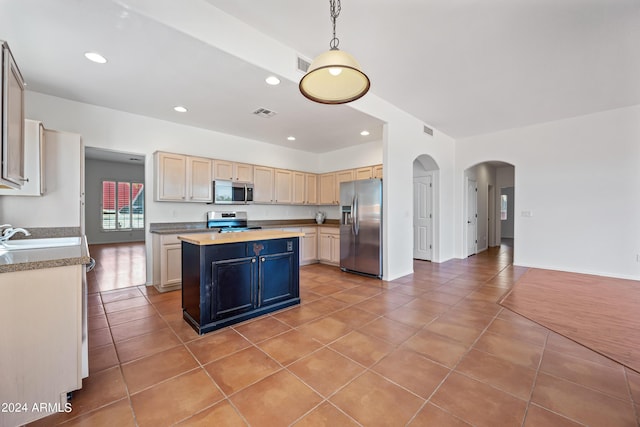 16914 E Britt Ct, Fountain Hills, AZ 85268 - kitchen featuring light tile patterned floors, a sink, appliances with stainless steel finishes, a center island, and arched walkways