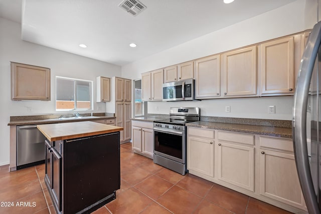 16914 E Britt Ct, Fountain Hills, AZ 85268 - kitchen with recessed lighting, tile patterned floors, visible vents, appliances with stainless steel finishes, and butcher block counters