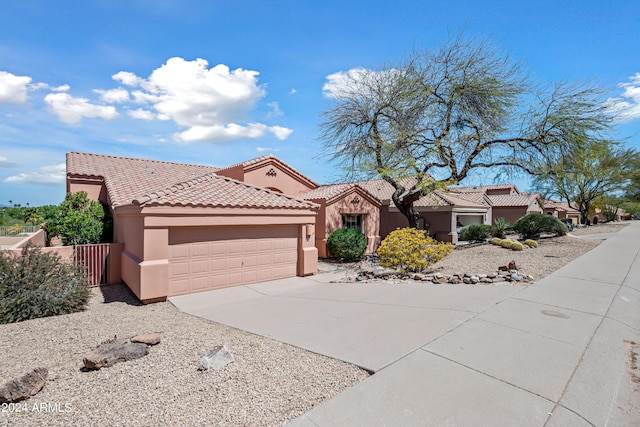 16914 E Britt Ct, Fountain Hills, AZ 85268 - mediterranean / spanish house featuring a garage, stucco siding, a tile roof, and concrete driveway