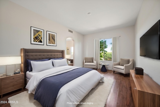 16914 E Britt Ct, Fountain Hills, AZ 85268 - bedroom with arched walkways, visible vents, and wood finished floors