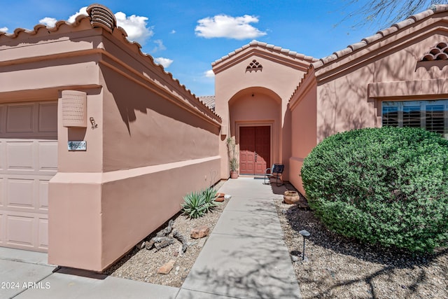16914 E Britt Ct, Fountain Hills, AZ 85268 - view of exterior entry featuring stucco siding, a garage, and a tile roof