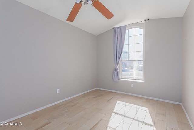 unfurnished room featuring light hardwood / wood-style floors, vaulted ceiling, and ceiling fan