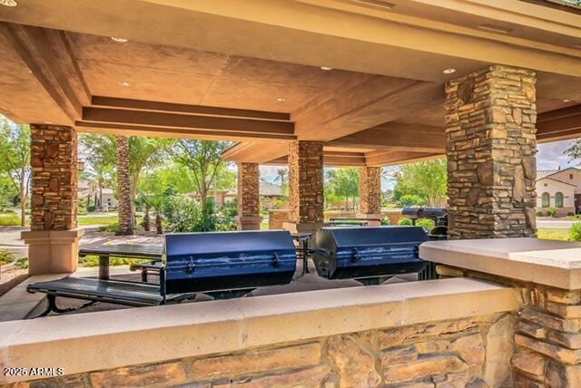 view of patio / terrace with exterior kitchen, a gazebo, and grilling area