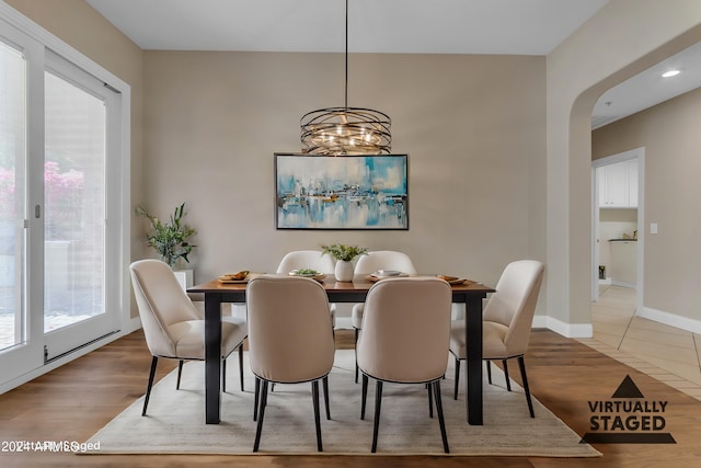 dining room with hardwood / wood-style flooring, plenty of natural light, and a chandelier