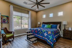 7409 E Weaver Way, Prescott Valley, AZ 86314 - bedroom with wood finished floors and a ceiling fan