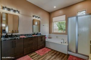 7409 E Weaver Way, Prescott Valley, AZ 86314 - bathroom featuring a garden tub, wood finished floors, healthy amount of natural light, and a shower stall