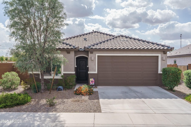 21882 N 260th Ln, Buckeye, AZ 85396 - mediterranean / spanish-style house featuring stucco siding, driveway, an attached garage, a tile roof, and fence