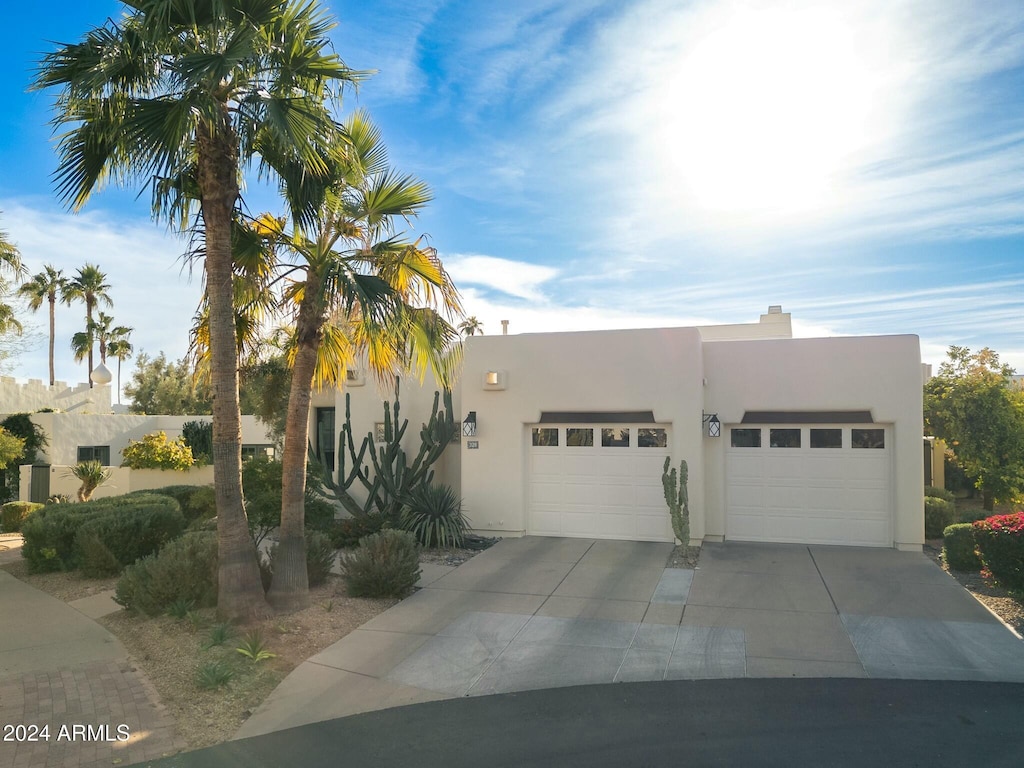 pueblo-style home with a garage