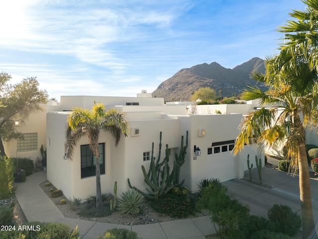 view of front facade featuring a mountain view and a garage