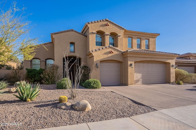 mediterranean / spanish-style home featuring concrete driveway, a tile roof, an attached garage, and stucco siding