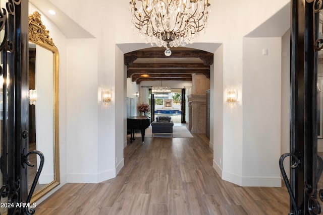 entrance foyer featuring beam ceiling and hardwood / wood-style flooring