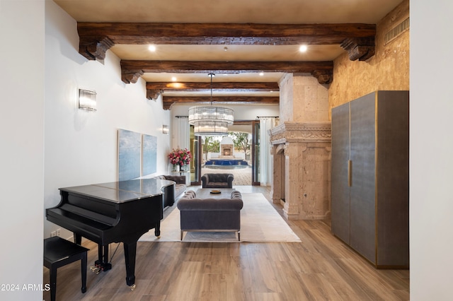 interior space featuring hardwood / wood-style flooring, beamed ceiling, and an inviting chandelier