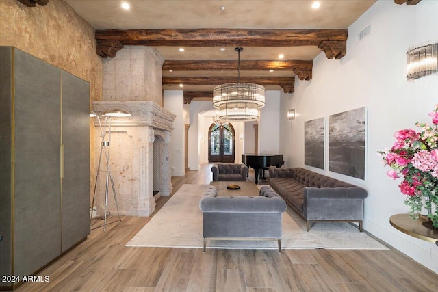 living room featuring beam ceiling, hardwood / wood-style flooring, and a chandelier