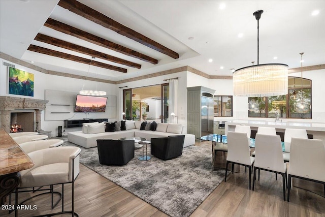 living room with beam ceiling, a healthy amount of sunlight, and dark hardwood / wood-style flooring