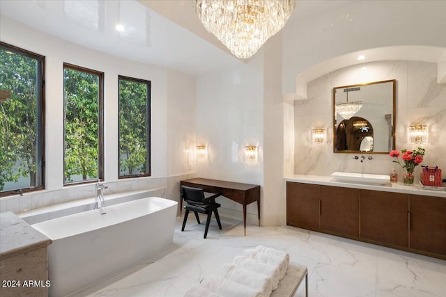 bathroom with vanity, a relaxing tiled tub, and tile walls