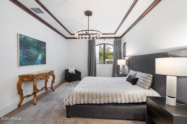 bedroom with light hardwood / wood-style floors, ornamental molding, and a chandelier