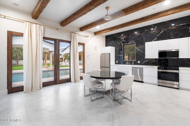 dining area with french doors, beam ceiling, and ceiling fan