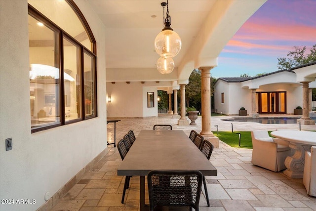 view of patio terrace at dusk