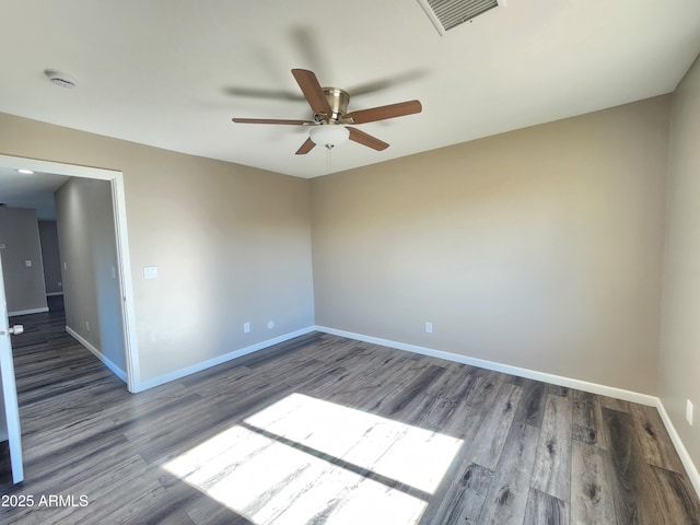 spare room with ceiling fan and wood-type flooring