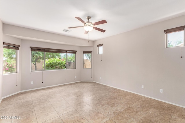 19319 E Thornton Rd, Queen Creek, AZ 85142 - empty room with plenty of natural light, ceiling fan, light tile patterned floors, and baseboards
