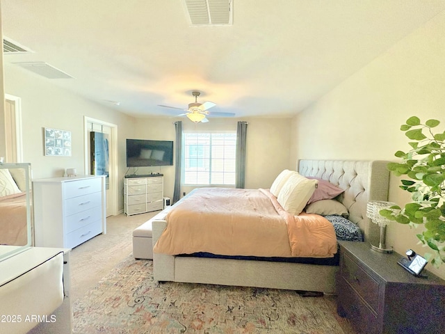 bedroom with ceiling fan and light carpet