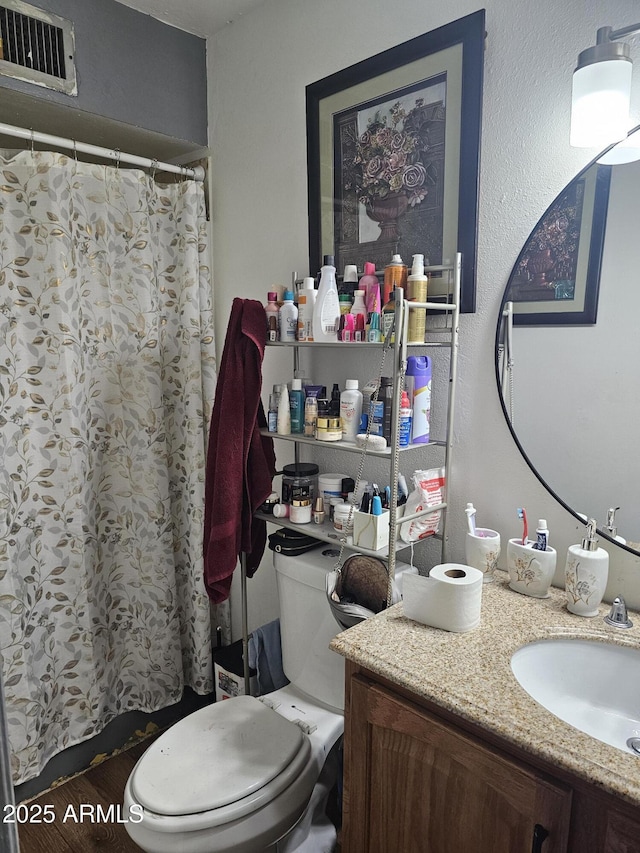 bathroom featuring vanity and toilet