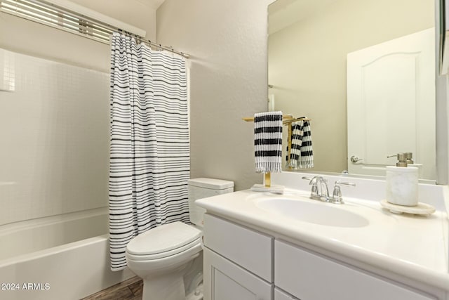 full bathroom with vanity, shower / tub combo, and toilet