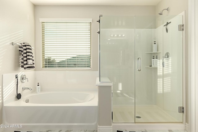 bathroom featuring shower with separate bathtub