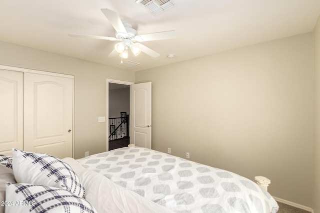 carpeted bedroom featuring a closet and ceiling fan