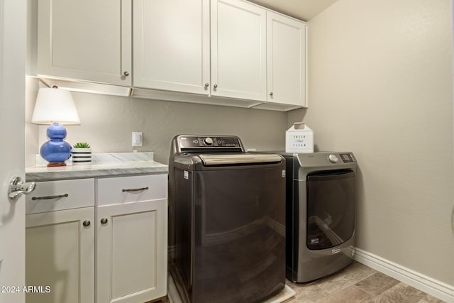 laundry area with cabinets and separate washer and dryer