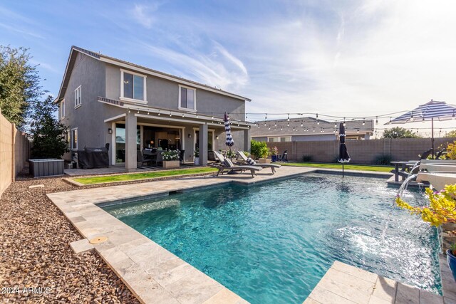 view of swimming pool featuring pool water feature and a patio area