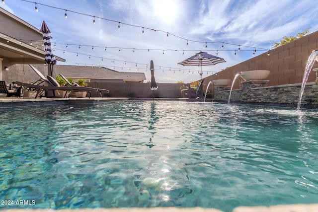 view of swimming pool with pool water feature