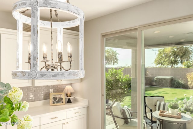 interior space with white cabinetry and backsplash