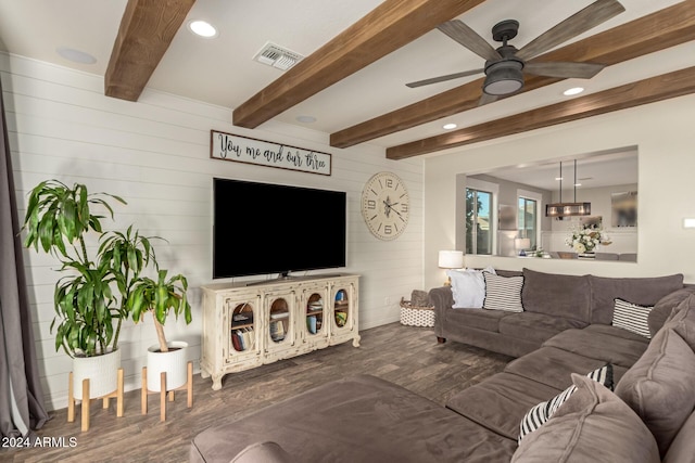 living room with beam ceiling, ceiling fan, and dark hardwood / wood-style flooring