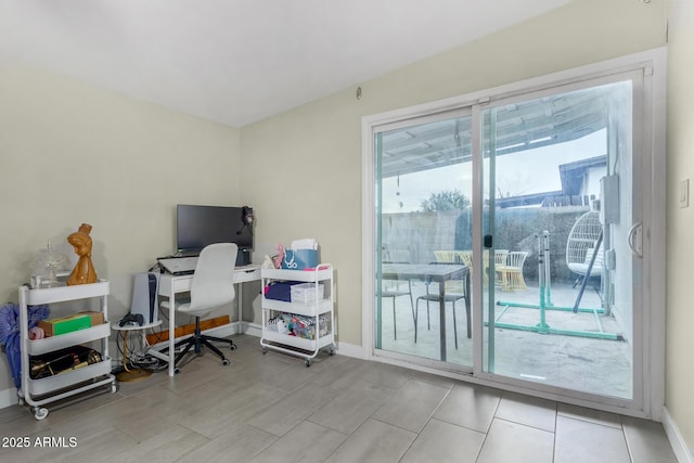 home office featuring baseboards and wood finished floors