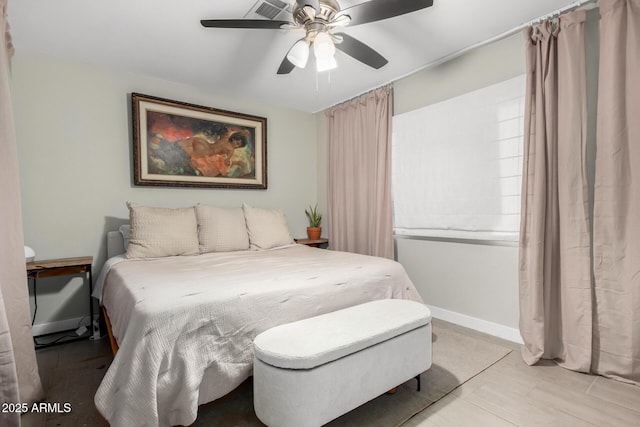 bedroom with ceiling fan and baseboards