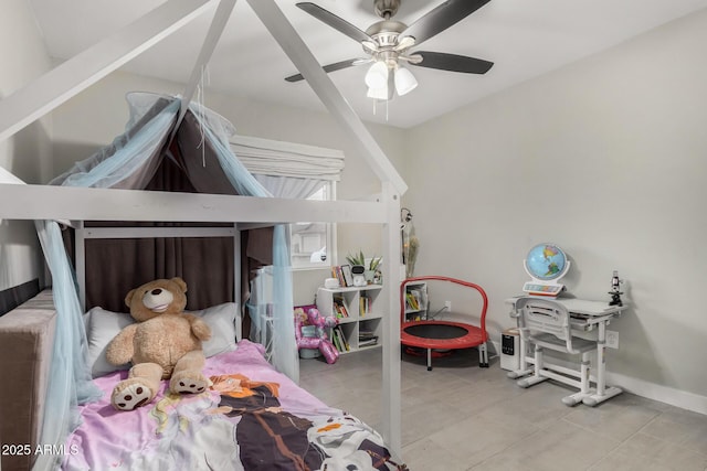 bedroom with a ceiling fan and baseboards