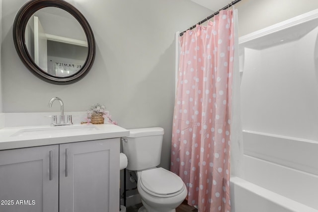 bathroom featuring shower / bath combo, vanity, and toilet