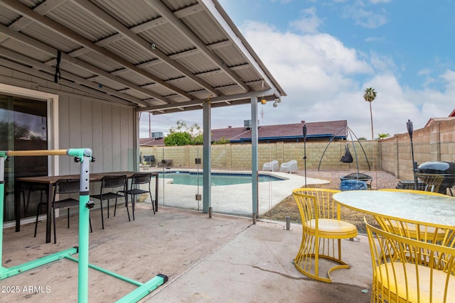 view of swimming pool featuring a patio, outdoor dining area, a fenced backyard, and a fenced in pool