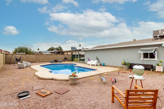 view of pool with a patio, central AC, a fenced backyard, and a fenced in pool