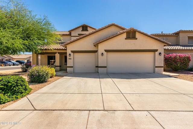 mediterranean / spanish house featuring a garage