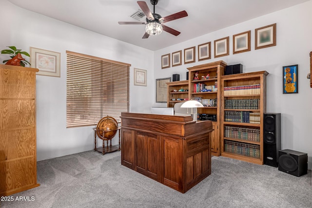 office space featuring carpet floors, ceiling fan, and visible vents