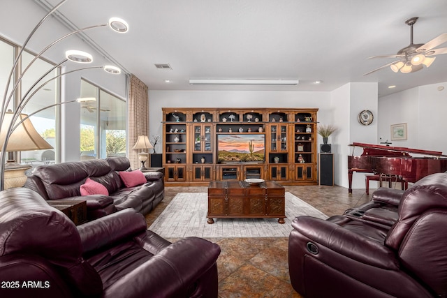 living room featuring visible vents and a ceiling fan
