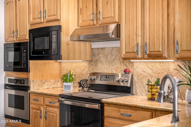 kitchen featuring under cabinet range hood, a sink, decorative backsplash, and appliances with stainless steel finishes