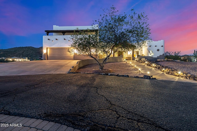 view of front of property with concrete driveway and stucco siding