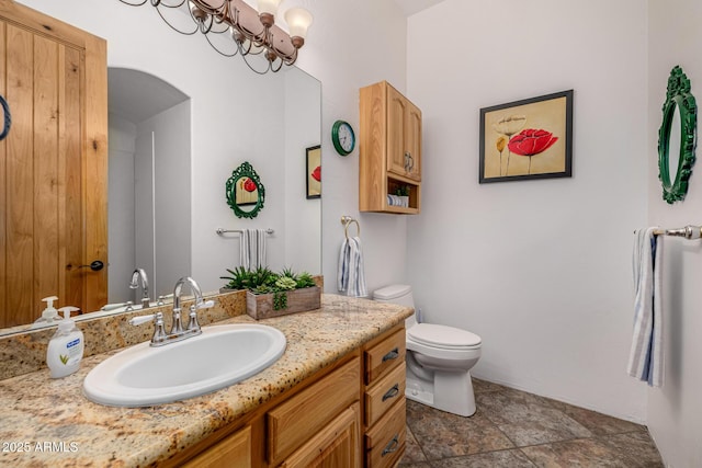 bathroom featuring toilet and vanity