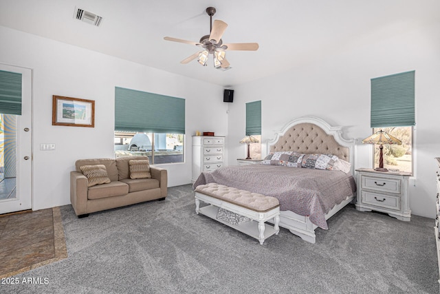 carpeted bedroom featuring ceiling fan and visible vents